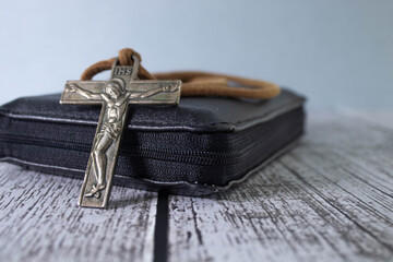 Concept of Palm Sunday, Good Friday, Lent and Holy Week. Bible, metal cross and green palm branches...