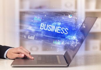 Closeup of businessman hands working on laptop