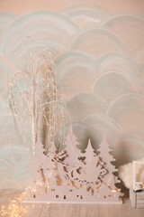 Decorative wooden landscape with trees and deer, ideal for creating a cozy Christmas atmosphere.