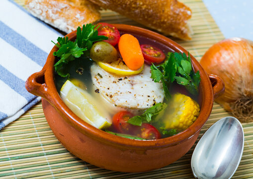 Recipe of pottage of fisherman: boil cod head for broth. Add potatoes, carrots, shallots, corn, fish steak 200 g, salt, pepper. Bring to oven, cook for 40min at temperature of 200 deg