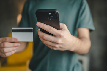teenager young man at home use credit card shopping online e-banking
