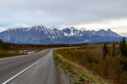 The Alaska Highway curves in front of Mt Archibald as it is going through Kluane National Park, Haines Junction, Yukon, Canada