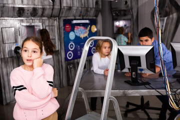 Emotional girl in quest room with friends, trying to find solution of conundrum