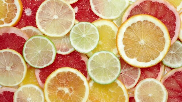 Slice of citrus fruit underwater or in water with splashing and droplet top view flat lay on white background.