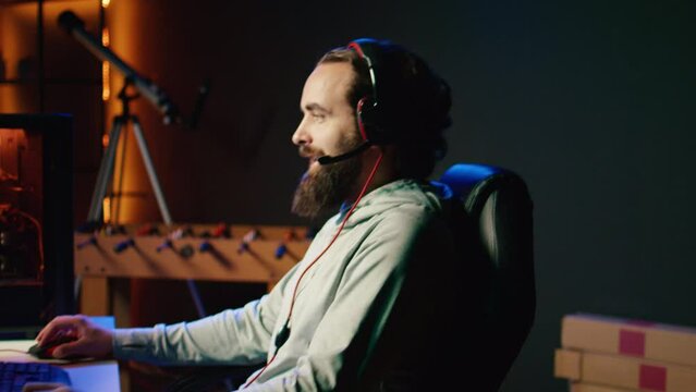 Smiling gamer restarting game after losing mission while playing spaceship videogame, feeling optimistic. Man happy to start again after getting flying spacecraft destroyed by more powerful enemies