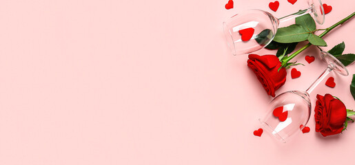 Wineglasses, roses and hearts on pink background with space for text. Valentine's Day celebration