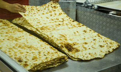 Process preparation of the traditional thin bread Lavash (pita bread) that forms an integral part...
