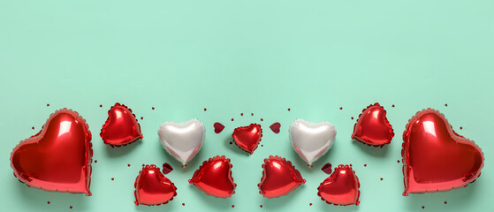 Heart-shaped balloons on turquoise background, flat lay. Valentine's Day celebration