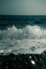 Ocean waves crashing on a sea shore, black volcanic rock on a Tenerife beach, Canary Islands blue water, coastline