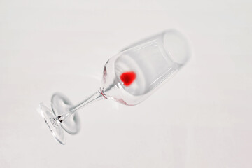 Wine glass with drop of red wine left, isolated on white. Dry january, quit drinking, alcohol...