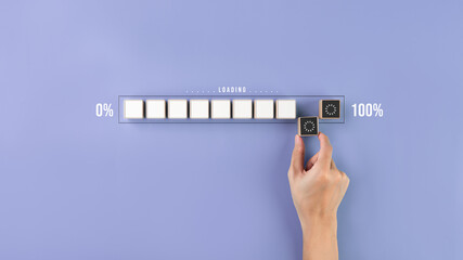 The business idea is in the implementation stage. ,Place wooden blocks by hand to make a loading progress bar on a purple background. ,Processing is not 100% complete.