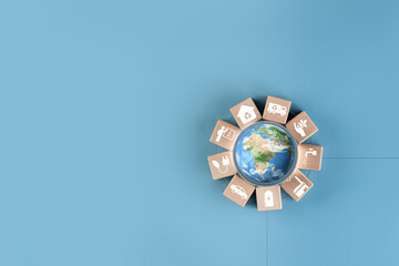 The globe is inside a glass globe surrounded by wooden blocks with eco-friendly campaign icons...