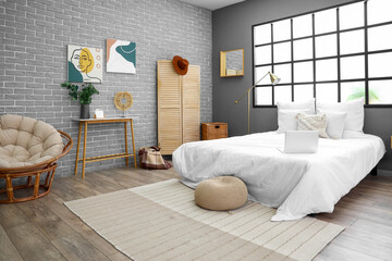 Interior of modern bedroom with bed and window