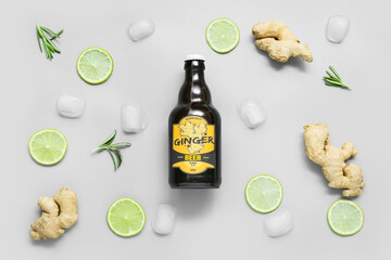 Composition with bottle of fresh ginger beer, lime slices and ice cubes on light background
