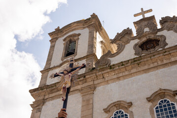Statue of Jesus Christ on the cross is raised by a Catholic faithful in front of the Senhor do Bonfim Church in the city of Salvador, Bahia.