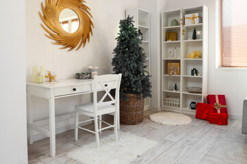 Stylish interior of light living room with beautiful Christmas tree