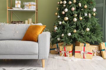 Comfortable sofa, Christmas tree and gifts in living room