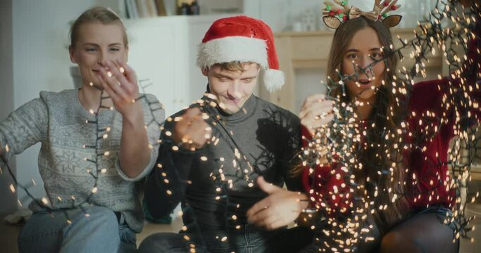 Man and women sorting tangled glowing lights