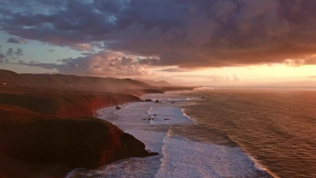 Aerial view on Legzira beach with arched rocks on the Atlantic coast at sunset in Morocco, 4k
