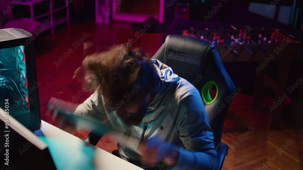 Poster angry man playing videogames at home, smashing head on keyboard after being defeated by enemies. com