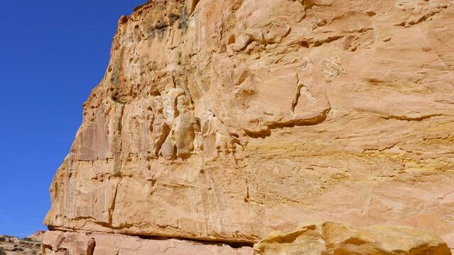 Establishing shot of female tourist at mountains in Hickman Natural Bridge Trail, Capital Reef National Park, Utah, North America. ProRes 422 HQ.
