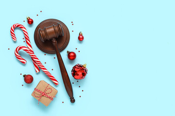 Composition with judge gavel and Christmas decorations on color background