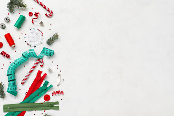 Composition with sewing accessories and Christmas decorations on light background