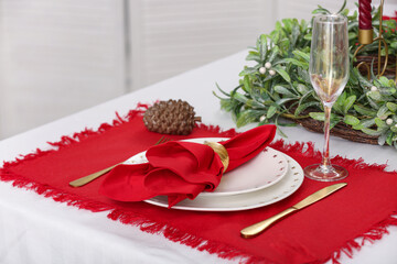 Beautiful Christmas table setting with dishes in kitchen, closeup