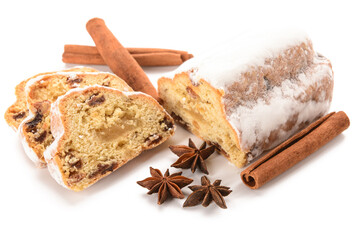 Tasty Christmas stollen with cinnamon and anise on white background
