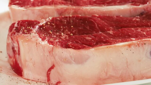 Seasoning raw meat in slow motion 