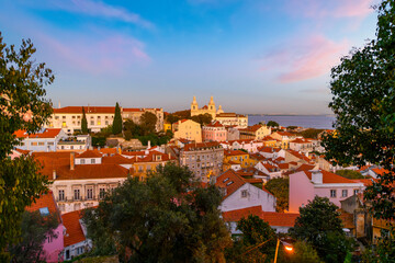 View of the Monastery of São Vicente de Fora and the hillside Alfama District from Saint George's Castle at sunset, in Lisbon, Portugal.