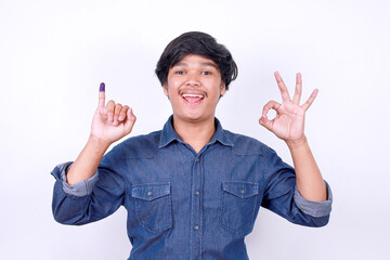 Happy Asian man showing ok sign gesture after voting on Indonesia presidential election 
