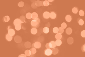 Peach Fuzz lights bokeh background, Chrismas lights bokeh. Monochrome abstract background. Blurred and glowing lights. Classic blue bokeh lens effect from lighting spots.