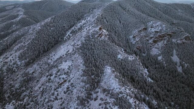 Denver Colorado Christmas first snow Mount Lindo memorial golden sunset 285 highway Morrison Conifer Evergreen Front Range Rocky Mountains aerial cinematic drone forward pan up motion slowly
