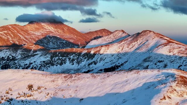 Mount Yale Colligate Peaks first snow golden hour aerial cinematic drone dramatic Rocky Mountains sunset pink orange red stunning freezing cold frozen Monarch Pass Salina Buena Vista Colorado backward
