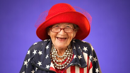 Closeup of laughing, funny, happy, patriotic grandmother mature woman, 80s, wearing US flag jacket isolated on purple background. Concept of youthful old female.