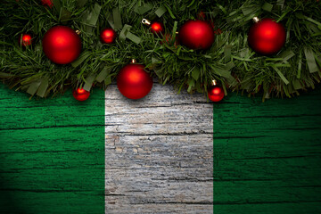 Christmas background made with garlands on a nigeria flag background. Christmas greeting from...