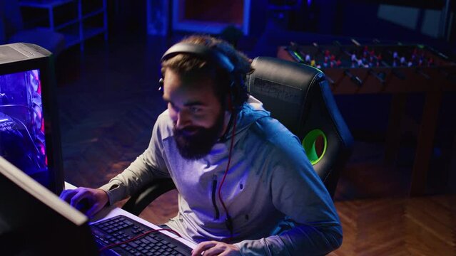 Man cursing opponents during online matchup while doing livestream for his internet channel watched by fans. Pro gamer being toxic towards other players, mocking and making fun of them