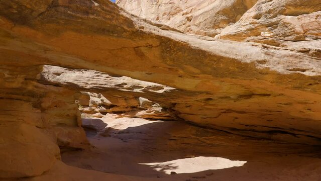 Establishing shot of mountain trail with red rocks in Hickman Natural Bridge Trail, Capital Reef National Park, Utah, North America. ProRes 422 HQ.