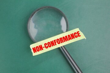 magnifying glass and selotape with the word non-conformance