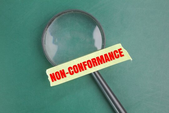 magnifying glass and selotape with the word non-conformance