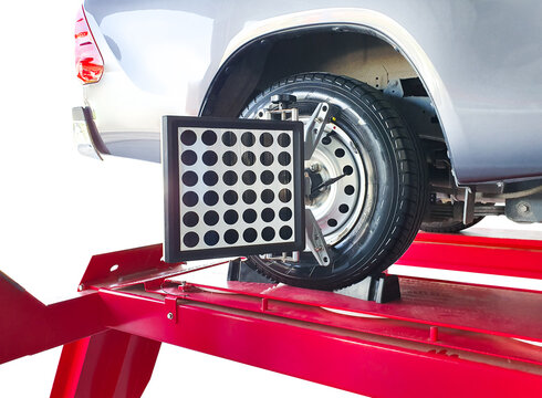 Wheel alignment of car on lifting stand with a laser sensor during suspension angle adjustment in car repair service center , Car maintenance service concept