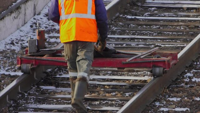 A worker checks the rails with a special device
