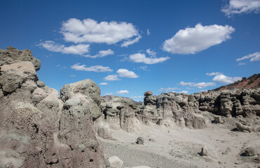 Fototapeta na wymiar Cloudy blue sky over eroded gray hodo formations in Little Book Cliffs National Monument near Grand Junction Colorado United States