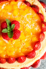Melt in your mouth, rich and delicious fresh baked mascarpone cheesecake with summer fruits and mango jelly.