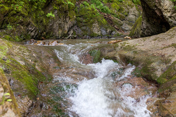 Fototapeta premium Mountain river spring season with sand and stone shoals along the banks.