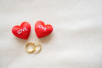 Couple golden ring classic design and shiny reflection with two tiny heart pillow forever love in...