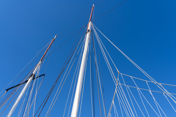 Ropes from sailship with blue sunny sky - obrazy, fototapety, plakaty