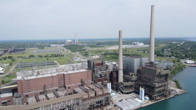 DTE St. Clair coal-fired power plant with coal piles in background, aerial view