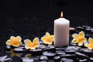 Fototapete beautiful spa setting of four frangipani   ,candle zen,basalt stones, closeup, spa concept  © Mee Ting
